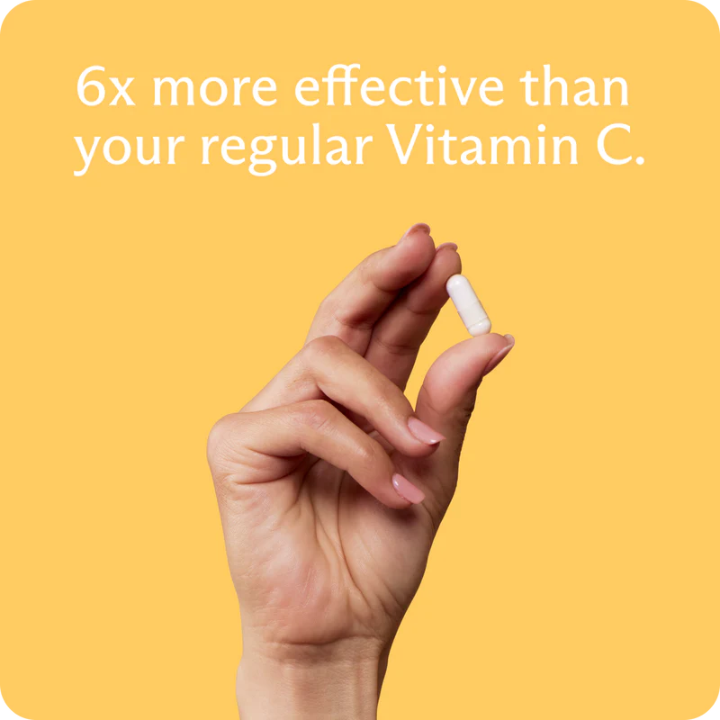 Hand holding a vitamin supplement with text on a yellow background