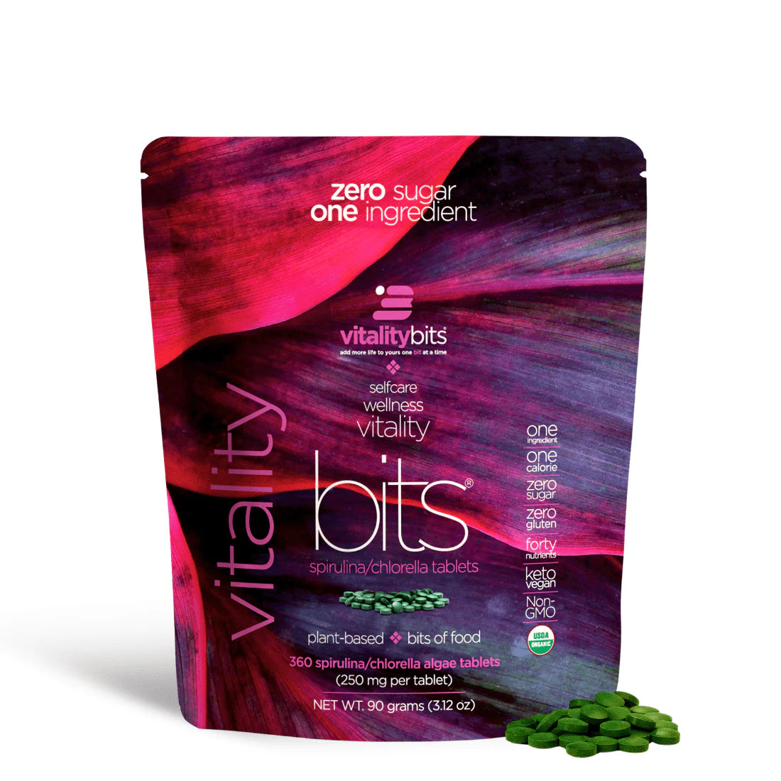 A small bag of VITALITYbits Spirulina/Chlorella, which are plant-based food supplements. The bag is purple and green, with text detailing the product name and ingredients, including 50% chlorella and 50% spirulina.