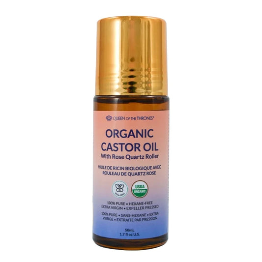 A roll-on bottle of Organic Golden Castor Oil with a rose quartz roller, labeled with product information.