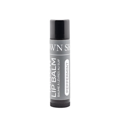 Lip balm container with 'Own Skin Co.' branding on a white background