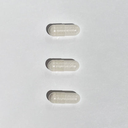 Three transparent capsules on a white background