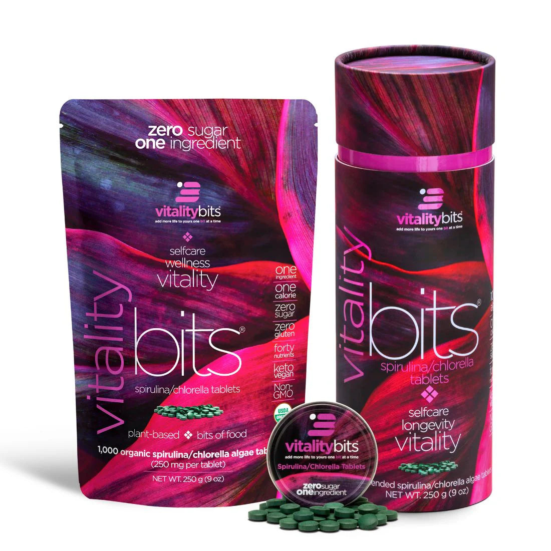 A large canister of VITALITYbits Spirulina/Chlorella with a colorful design, alongside a smaller container and several tablets, all branded with the VITALITYbits logo.