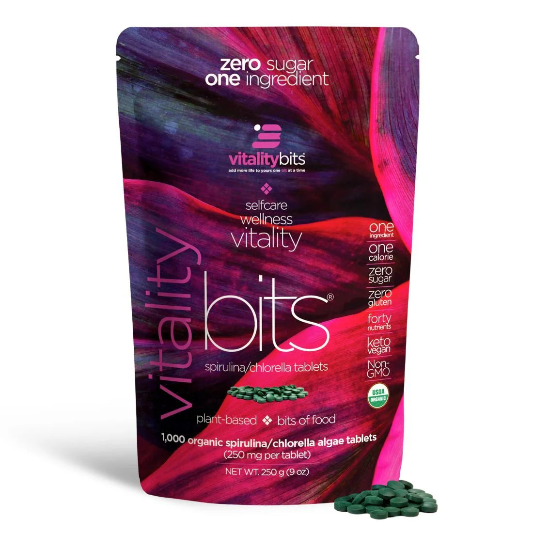 A package of VITALITYbits Spirulina/Chlorella blended tablets with a purple and pink design, highlighting the product's key features such as being zero sugar, one ingredient, and having 2000 mg of spirulina and 1000 mg of chlorella.